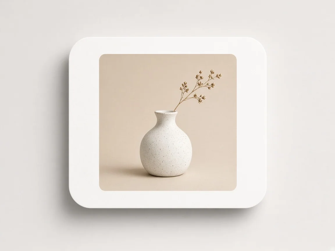 Framed photograph of a ceramic vase on a pale studio card